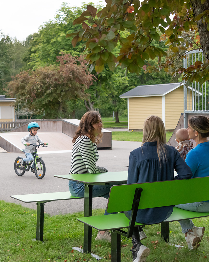 Mothers sittion on Ekeby furniture in HPL watching the kids play.